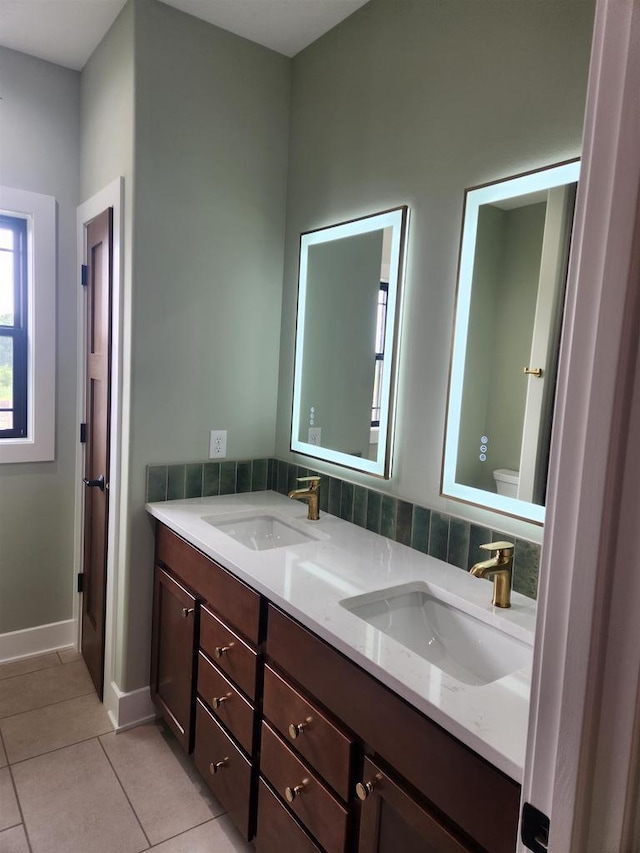 1100 Moll Dr, Waunakee, WI 53597 - full bathroom with toilet, tile patterned flooring, double vanity, and baseboards