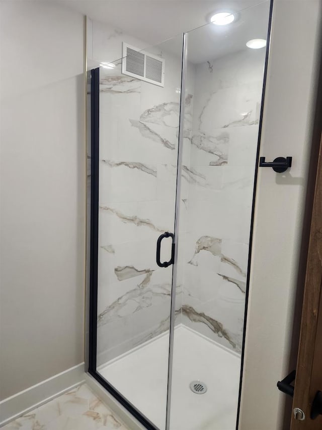 1100 Moll Dr, Waunakee, WI 53597 - bathroom with a marble finish shower, marble look tiles, and baseboards