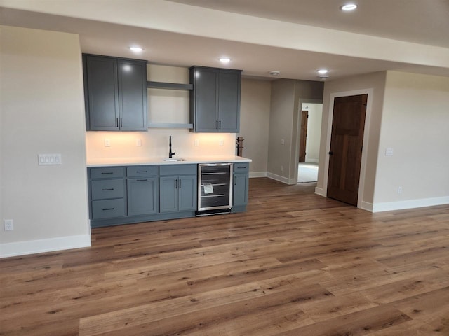 1100 Moll Dr, Waunakee, WI 53597 - kitchen with beverage cooler, a sink, recessed lighting, and baseboards