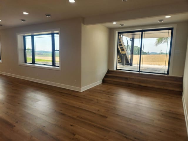 1100 Moll Dr, Waunakee, WI 53597 - unfurnished room with baseboards, healthy amount of natural light, recessed lighting, and dark wood finished floors