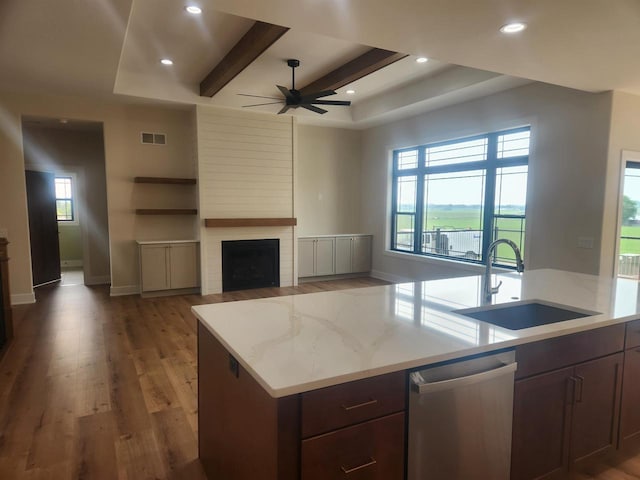 1100 Moll Dr, Waunakee, WI 53597 - kitchen featuring stainless steel dishwasher, a sink, a ceiling fan, baseboards, and wood finished floors