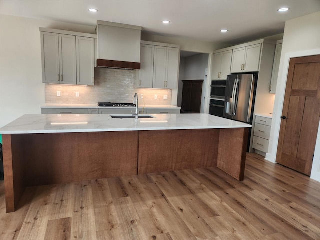 1100 Moll Dr, Waunakee, WI 53597 - kitchen featuring custom exhaust hood, decorative backsplash, light wood-style floors, gray cabinets, and a sink