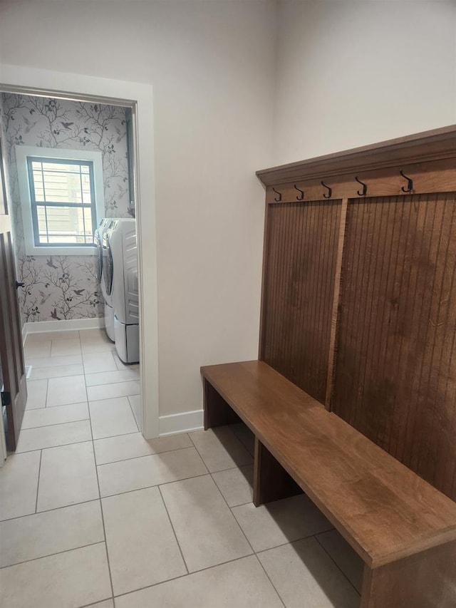 1100 Moll Dr, Waunakee, WI 53597 - mudroom with washer and clothes dryer, baseboards, wallpapered walls, and light tile patterned floors
