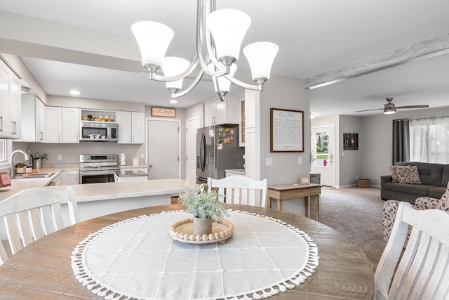 30 Highland Ave, Ripon, WI 54971 - dining room featuring healthy amount of natural light, a ceiling fan, recessed lighting, a chandelier, and light colored carpet