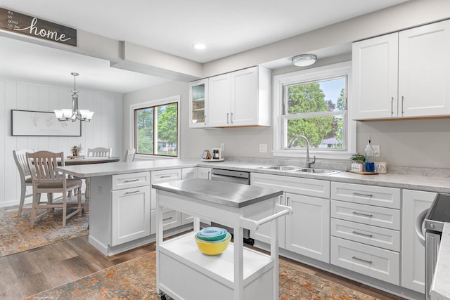 30 Highland Ave, Ripon, WI 54971 - kitchen featuring a sink, a peninsula, dishwasher, light countertops, and white cabinetry