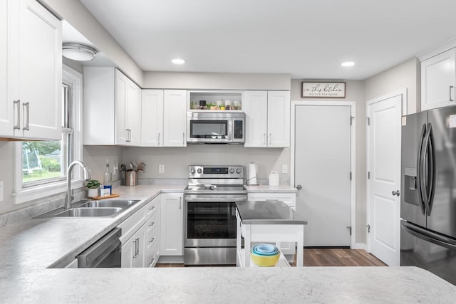 30 Highland Ave, Ripon, WI 54971 - kitchen with appliances with stainless steel finishes, a sink, wood finished floors, white cabinets, and recessed lighting