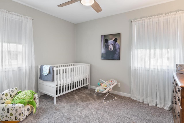 30 Highland Ave, Ripon, WI 54971 - carpeted bedroom featuring multiple windows, a nursery area, ceiling fan, and baseboards