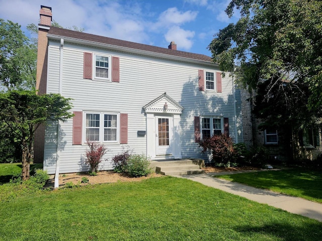 3330 S 47th St, Greenfield, WI 53219 - colonial-style house featuring a chimney and a front lawn