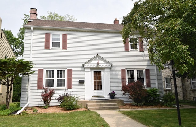 3330 S 47th St, Greenfield, WI 53219 - colonial house featuring a chimney and a front lawn