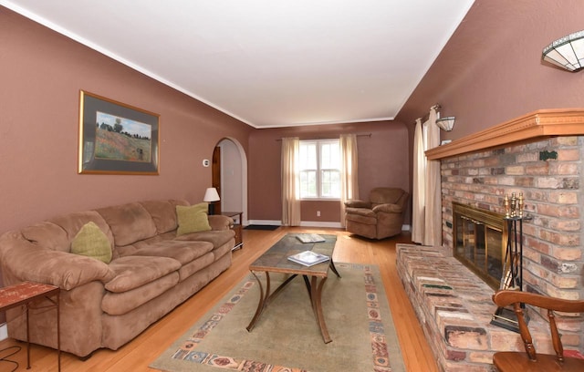 3330 S 47th St, Greenfield, WI 53219 - living room featuring arched walkways, wood finished floors, and a brick fireplace