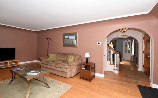 3330 S 47th St, Greenfield, WI 53219 - living area featuring arched walkways, light wood finished floors, and stairs