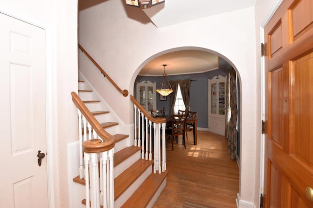 3330 S 47th St, Greenfield, WI 53219 - foyer with arched walkways, a chandelier, wood finished floors, and stairs