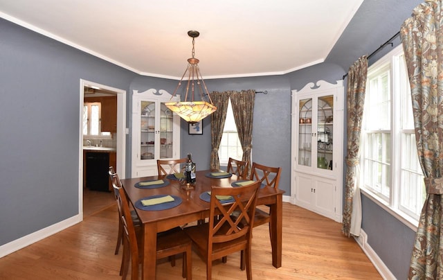 3330 S 47th St, Greenfield, WI 53219 - dining space with light wood-style floors and ornamental molding