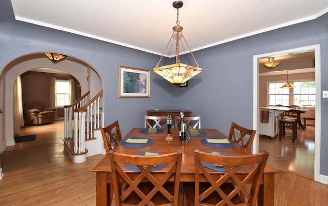 3330 S 47th St, Greenfield, WI 53219 - dining space featuring arched walkways, wood finished floors, plenty of natural light, and stairway