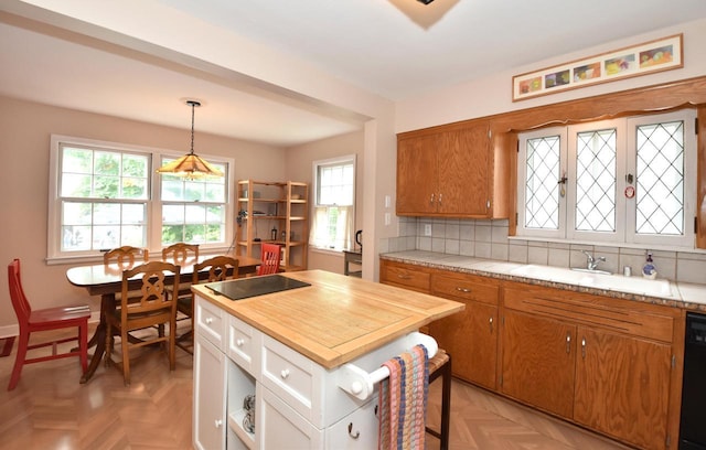 3330 S 47th St, Greenfield, WI 53219 - kitchen with brown cabinets, decorative backsplash, decorative light fixtures, and black appliances