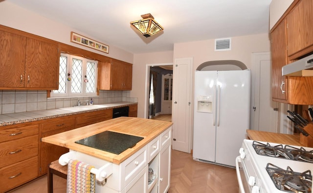3330 S 47th St, Greenfield, WI 53219 - kitchen with black appliances, brown cabinets, tile counters, and backsplash
