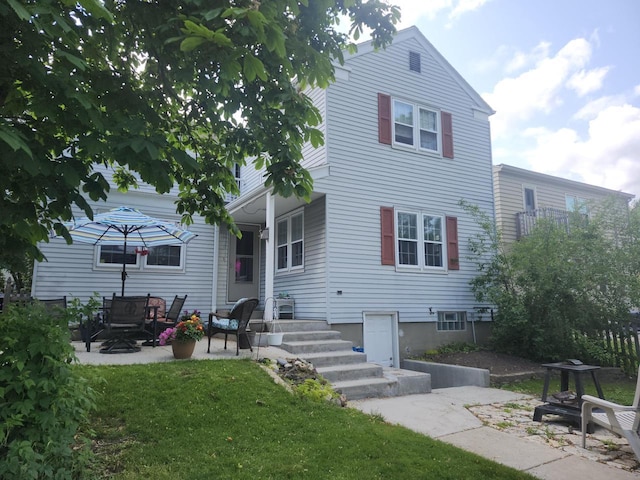 3330 S 47th St, Greenfield, WI 53219 - back of property featuring a lawn and a patio