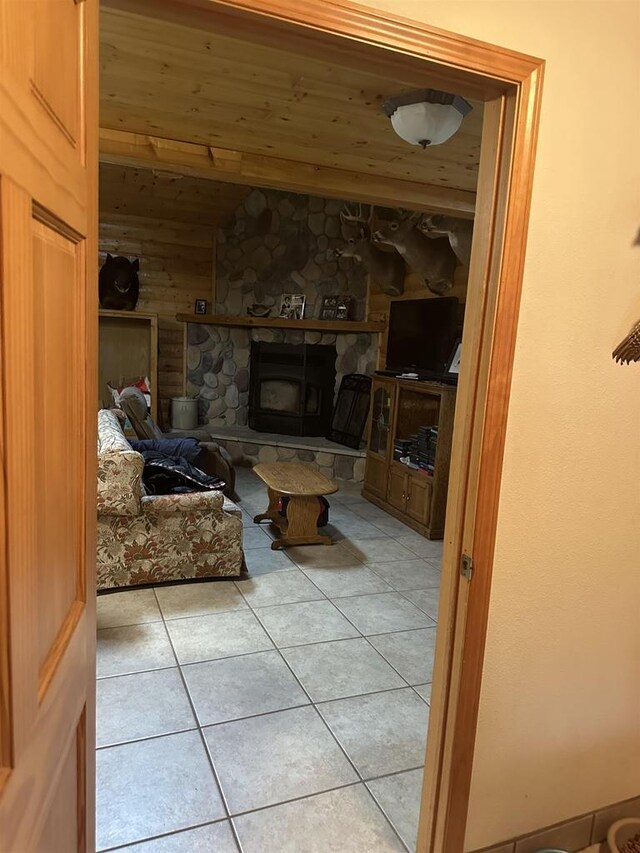 58875 Roy Anderson Rd, Mason, WI 54856 - living room featuring light tile patterned floors, a fireplace, and vaulted ceiling