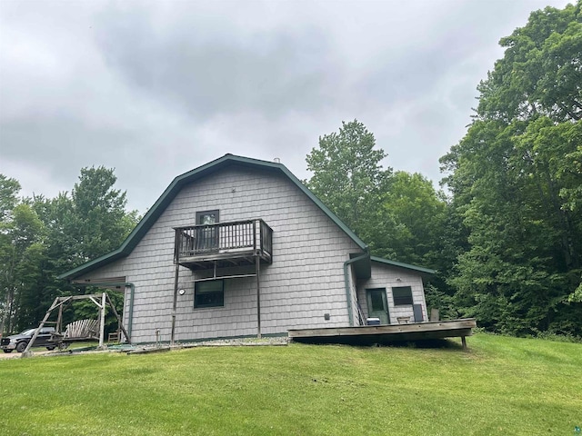 58875 Roy Anderson Rd, Mason, WI 54856 - rear view of property featuring a balcony, a lawn, and a wooden deck