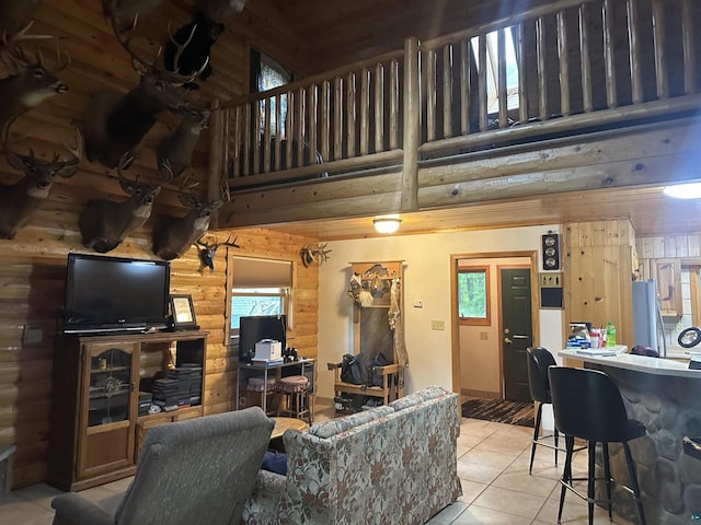58875 Roy Anderson Rd, Mason, WI 54856 - living room featuring tile patterned floors, a towering ceiling, and log walls