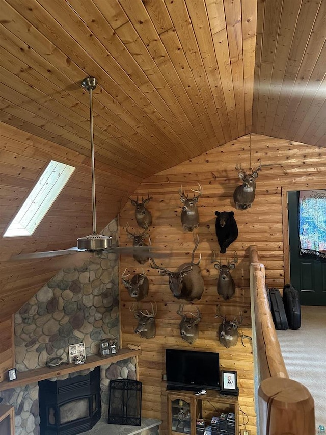 58875 Roy Anderson Rd, Mason, WI 54856 - carpeted living room featuring wooden ceiling, lofted ceiling, a skylight, and log walls