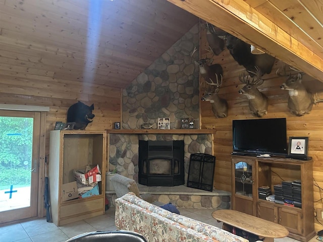 58875 Roy Anderson Rd, Mason, WI 54856 - living area featuring light tile patterned floors, a wood stove, lofted ceiling, wood walls, and wooden ceiling