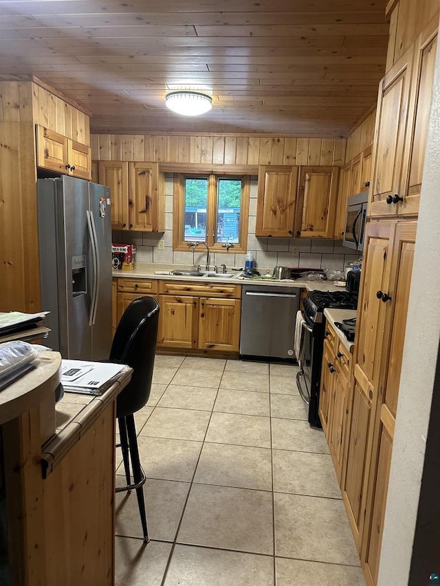 58875 Roy Anderson Rd, Mason, WI 54856 - kitchen with stainless steel appliances, a sink, wooden ceiling, light countertops, and light tile patterned floors