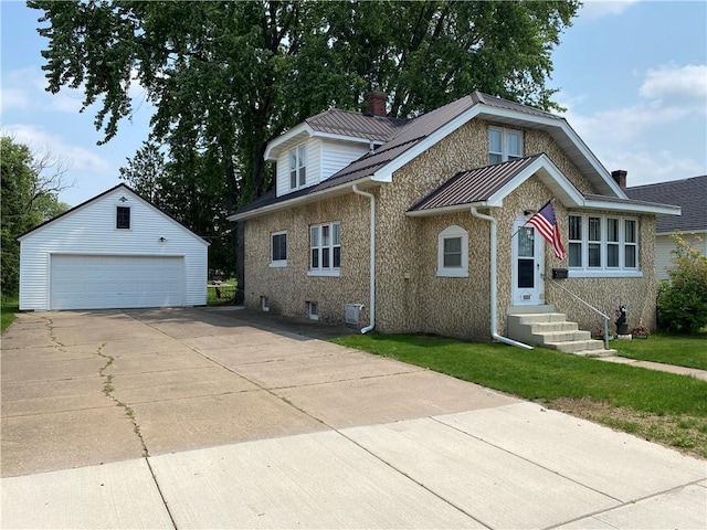 1114 Newman St, Bloomer, WI 54724 - view of front facade featuring an outbuilding, a detached garage, a chimney, entry steps, and brick siding
