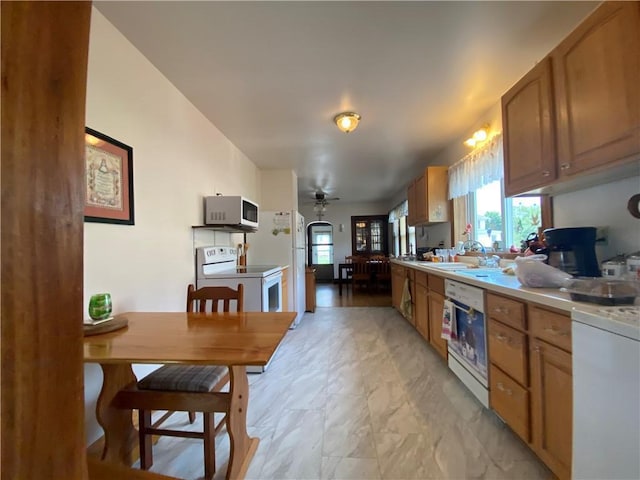 1114 Newman St, Bloomer, WI 54724 - kitchen featuring white appliances, light countertops, and brown cabinetry