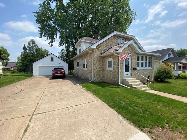 1114 Newman St, Bloomer, WI 54724 - view of front facade with an outdoor structure, a garage, a front yard, brick siding, and metal roof