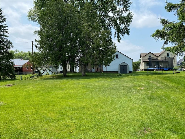 1114 Newman St, Bloomer, WI 54724 - view of green lawn featuring a trampoline