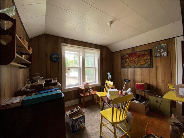 1114 Newman St, Bloomer, WI 54724 - living area featuring vaulted ceiling, wood walls, and carpet flooring