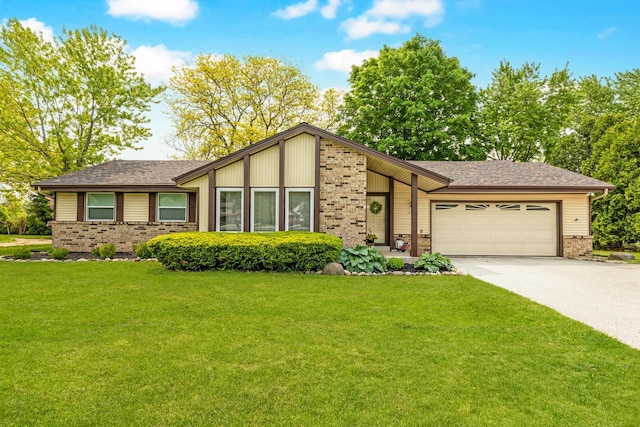 4951 W Joleno Ln, Brown Deer, WI 53223 - mid-century modern home featuring brick siding, a garage, a front yard, and concrete driveway