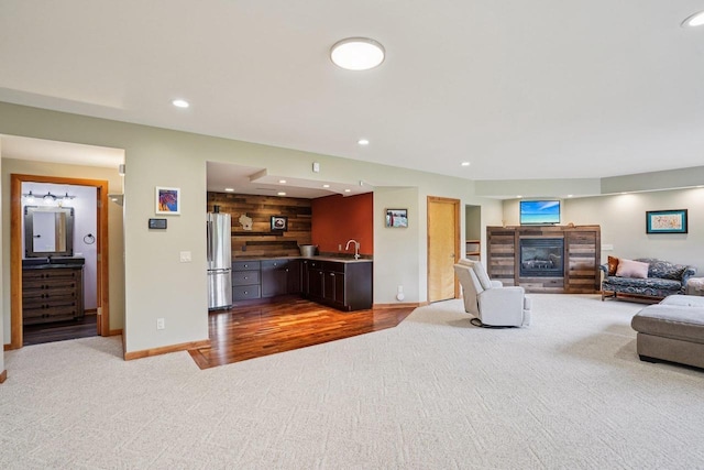 7965 Westhill Cir, Verona, WI 53593 - carpeted living area featuring a glass covered fireplace, recessed lighting, wet bar, and baseboards