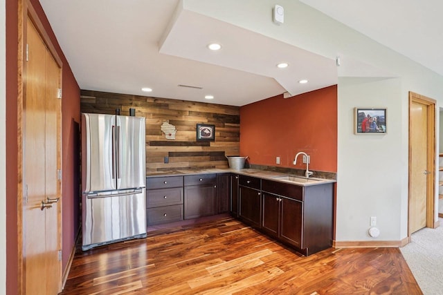 7965 Westhill Cir, Verona, WI 53593 - kitchen with freestanding refrigerator, a sink, wood walls, recessed lighting, and dark brown cabinetry