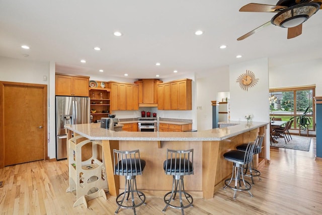 7965 Westhill Cir, Verona, WI 53593 - kitchen with open shelves, stainless steel appliances, recessed lighting, light wood-type flooring, and a breakfast bar