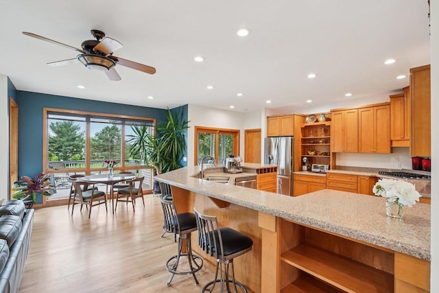 7965 Westhill Cir, Verona, WI 53593 - kitchen with open shelves, appliances with stainless steel finishes, a sink, recessed lighting, and light stone countertops