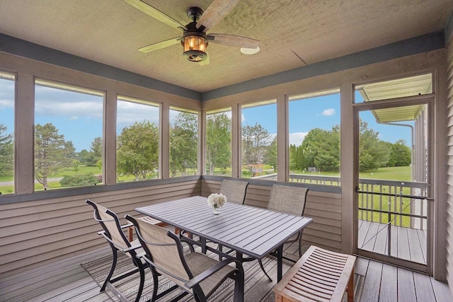 7965 Westhill Cir, Verona, WI 53593 - sunroom / solarium featuring a ceiling fan, outdoor dining space, view of scattered trees, and plenty of natural light