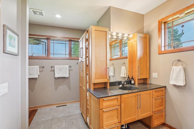 7965 Westhill Cir, Verona, WI 53593 - bathroom featuring vanity, baseboards, and recessed lighting