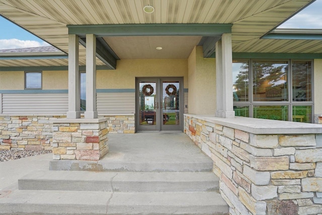 7965 Westhill Cir, Verona, WI 53593 - doorway to property featuring stucco siding, stone siding, and french doors