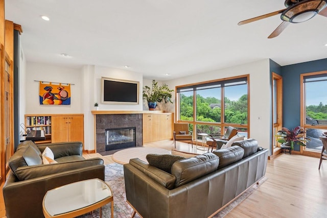 7965 Westhill Cir, Verona, WI 53593 - living room featuring plenty of natural light, wood finished floors, a fireplace with flush hearth, a ceiling fan, and recessed lighting