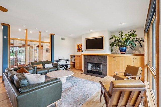 7965 Westhill Cir, Verona, WI 53593 - living area featuring wood finished floors, a tiled fireplace, and recessed lighting
