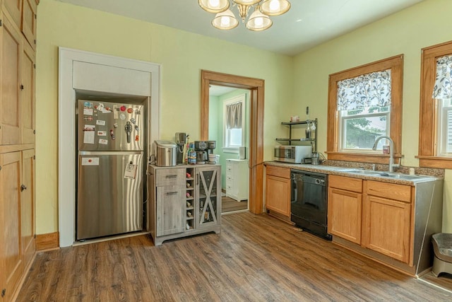 1600 15th Ave, Monroe, WI 53566 - kitchen with appliances with stainless steel finishes, wood finished floors, and a chandelier