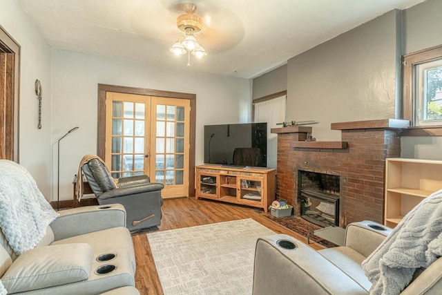1600 15th Ave, Monroe, WI 53566 - living area with wood finished floors, a fireplace, french doors, and a ceiling fan