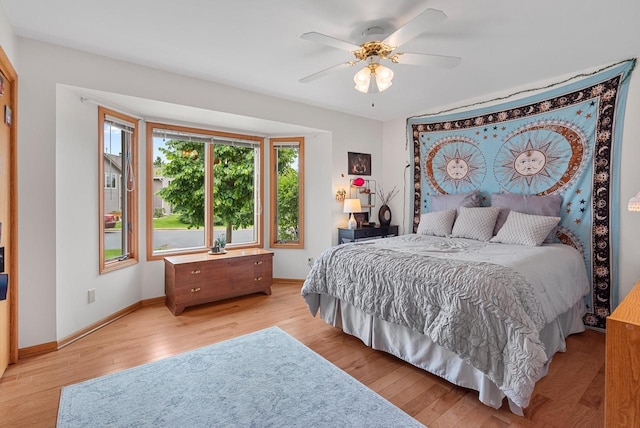 1300 Hidden Fields Dr, West Bend, WI 53095 - bedroom with light wood-style flooring and ceiling fan