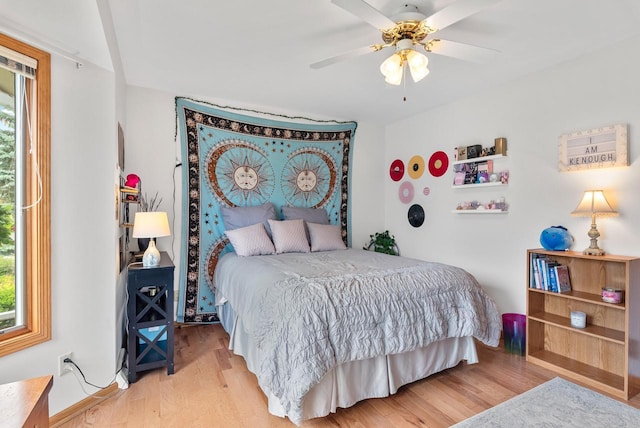 1300 Hidden Fields Dr, West Bend, WI 53095 - bedroom with multiple windows, wood finished floors, and a ceiling fan