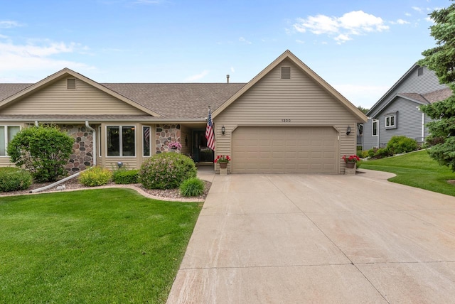1300 Hidden Fields Dr, West Bend, WI 53095 - view of front of home featuring a garage, a front yard, concrete driveway, roof with shingles, and stone siding