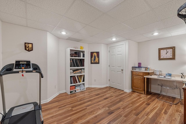 1300 Hidden Fields Dr, West Bend, WI 53095 - workout area featuring light wood-type flooring, a paneled ceiling, and recessed lighting