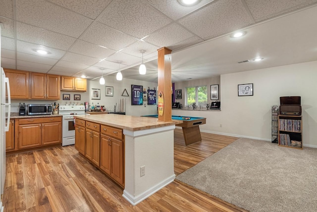1300 Hidden Fields Dr, West Bend, WI 53095 - kitchen featuring electric stove, stainless steel microwave, light wood-style flooring, a paneled ceiling, and open floor plan