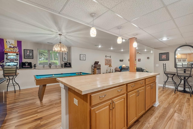 1300 Hidden Fields Dr, West Bend, WI 53095 - kitchen featuring light wood-type flooring, a drop ceiling, wooden counters, pendant lighting, and billiards table